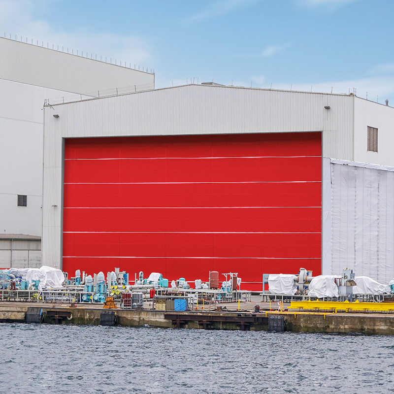 Vertical lifting shipyard door for large clear openings