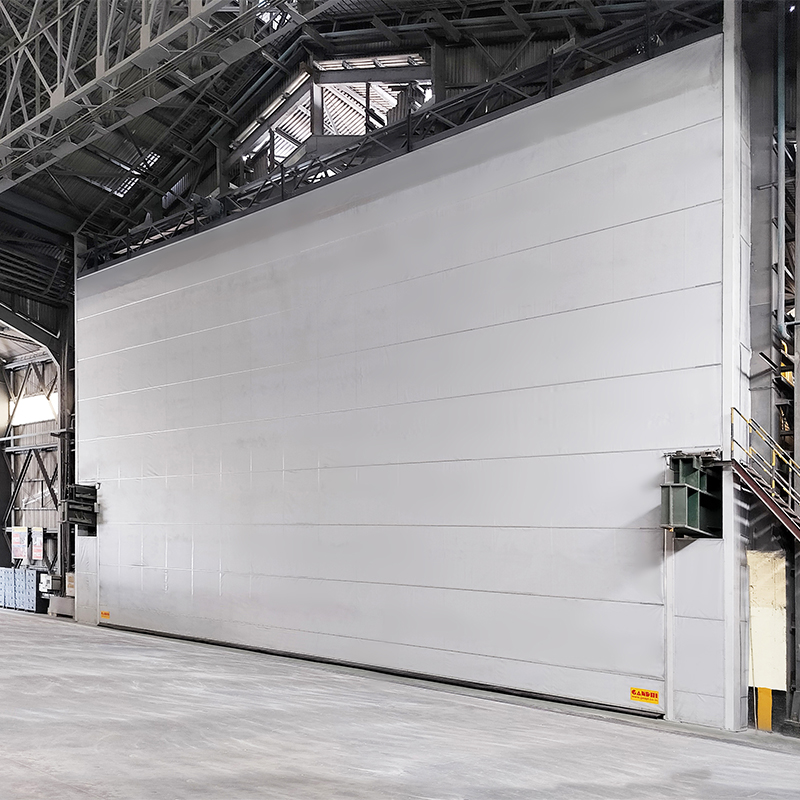 Overhead crane compatible door system for large facilities